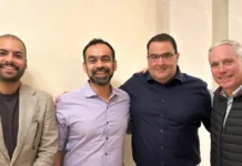 Element Logic and Ranpak Join Forces to Advance Packaging Automation Four men stand side by side indoors, smiling at the camera with relaxed poses.